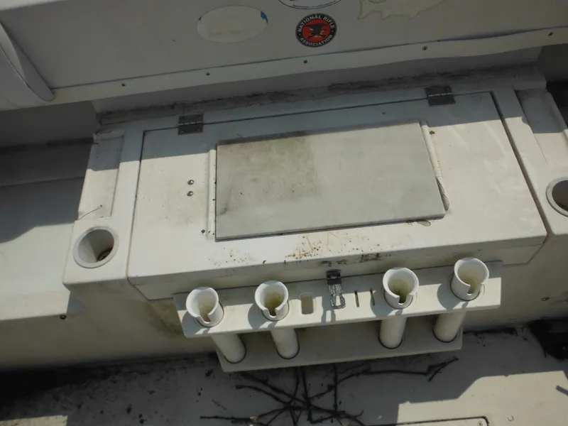 Slide: The Image of 1988 Grady-White Offshore 240 boat interior with rod holders and storage compartment. - 29