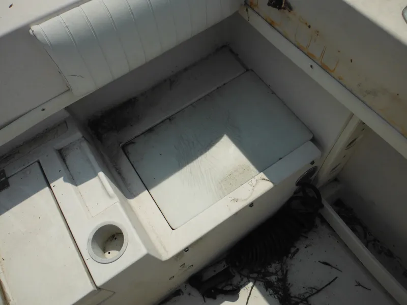 Slide: The Image of 1988 Grady-White Offshore 240 boat interior with storage compartment and cup holder. - 31