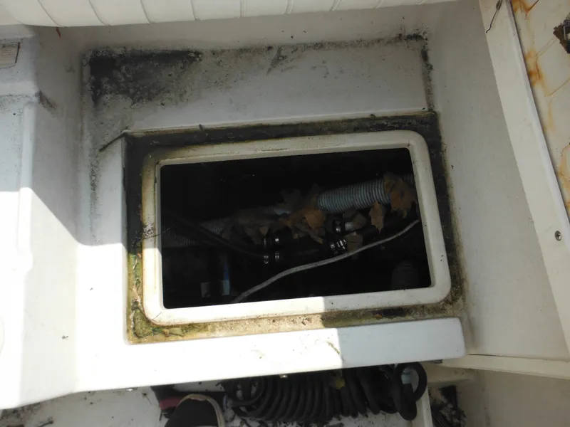 Slide: The Image of 1988 Grady-White Offshore 240 boat compartment with visible wiring and debris. - 32