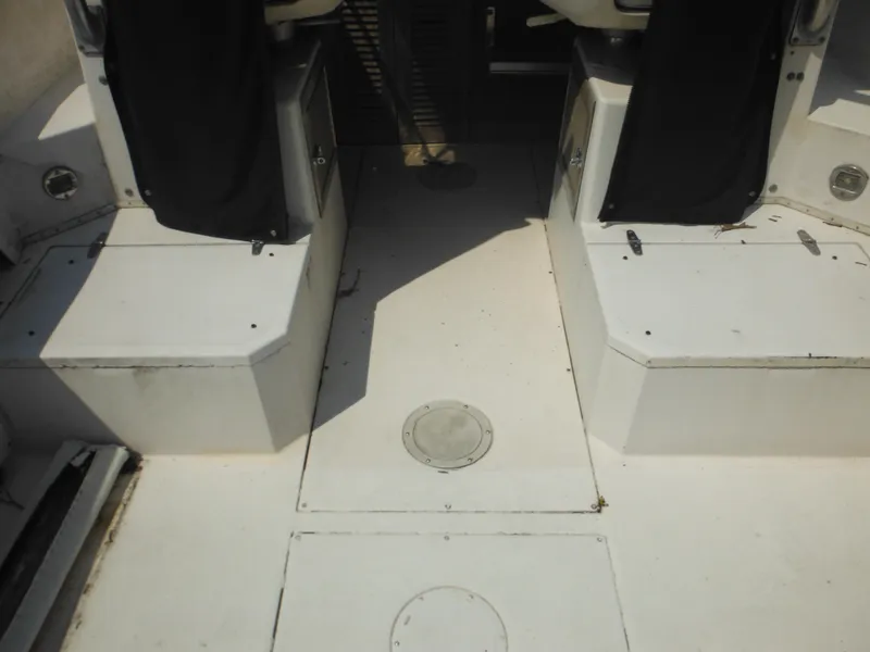 Slide: The Image of 1988 Grady-White Offshore 240 boat interior with white deck and storage compartments. - 35