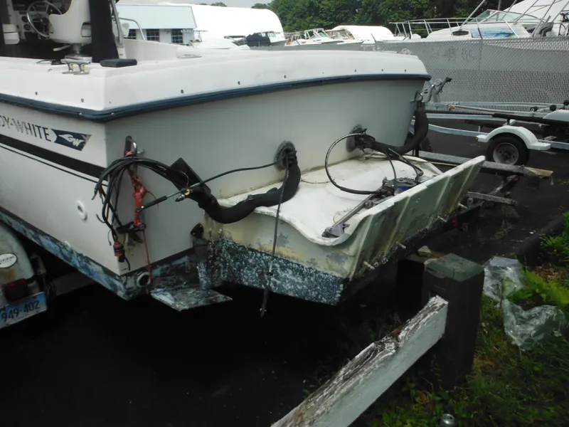 Slide: The Image of 1988 Grady-White Offshore 240 boat with visible wear, parked on a trailer. - 4