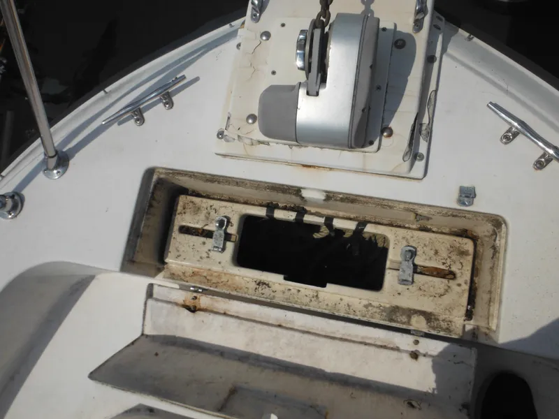 Slide: The Image of 1988 Grady-White Offshore 240 boat deck with anchor winch and storage compartment. - 42