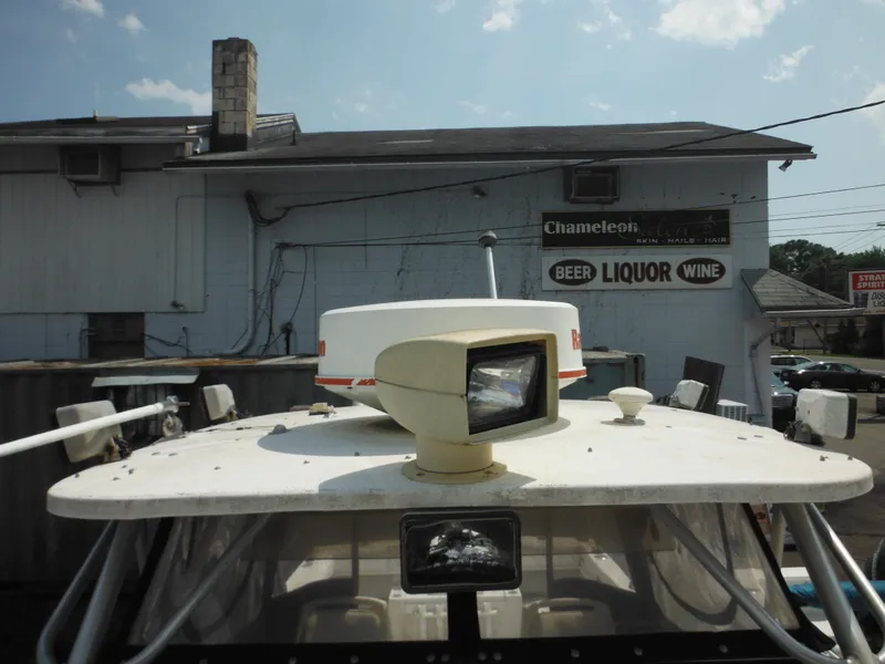 Slide: The Image of 1988 Grady-White Offshore 240 boat with radar, parked near liquor store. - 45