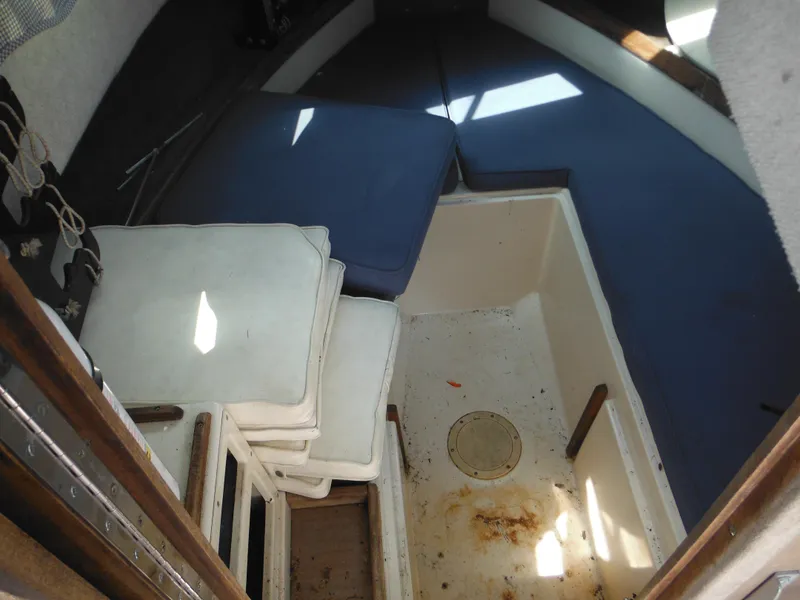 Slide: The Image of Interior cabin of 1988 Grady-White Offshore 240 boat with cushions and storage area. - 48