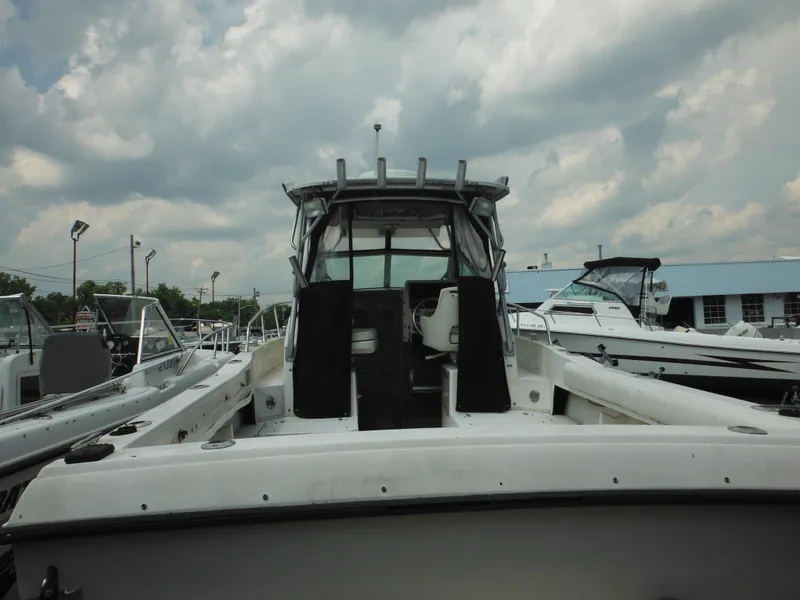 Slide: The Image of 1988 Grady-White Offshore 240 boat docked under cloudy sky. - 5