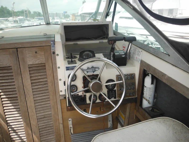 Slide: The Image of 1988 Grady-White Offshore 240 boat helm with steering wheel and control panel. - 7