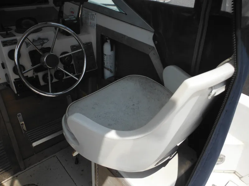 Slide: The Image of 1988 Grady-White Offshore 240 boat interior with steering wheel and captain's chair. - 9