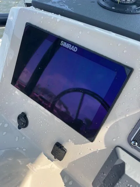 Slide: The Image of Simrad display on 2024 Boston Whaler 210 Montauk boat dashboard, wet with water droplets. - 11