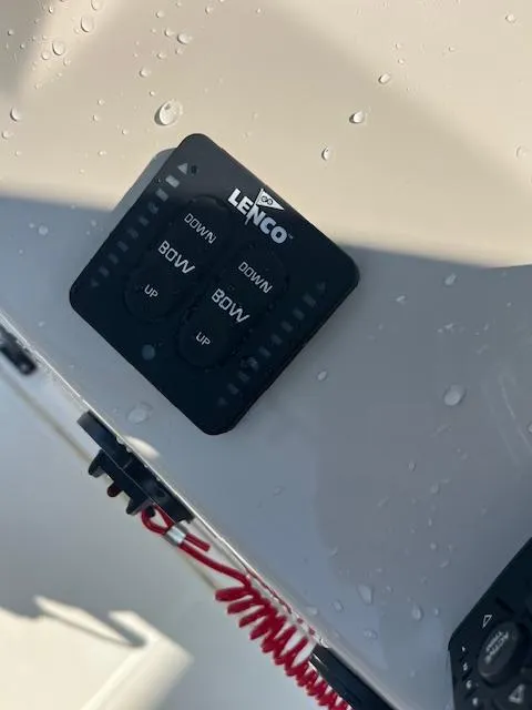 Slide: The Image of Control panel on 2024 Boston Whaler 210 Montauk boat with Lenco trim tab switches. - 12