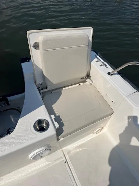 Slide: The Image of 2024 Boston Whaler 210 Montauk boat seat with cup holder, on calm water. - 15