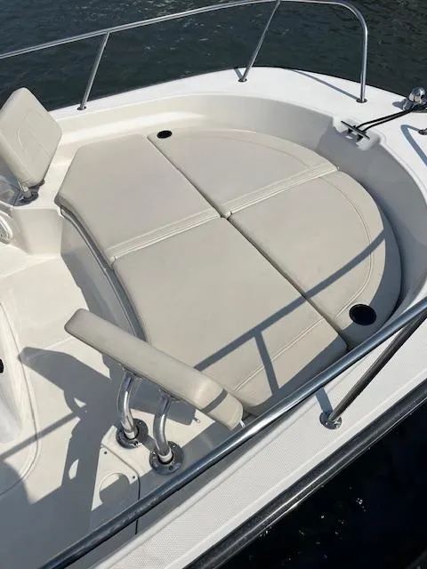 Slide: The Image of 2024 Boston Whaler 210 Montauk boat with cushioned seating and stainless steel railings. - 3
