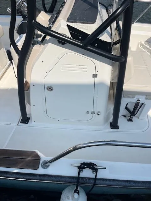 Slide: The Image of 2024 Boston Whaler 210 Montauk boat interior with console and seating area. - 6