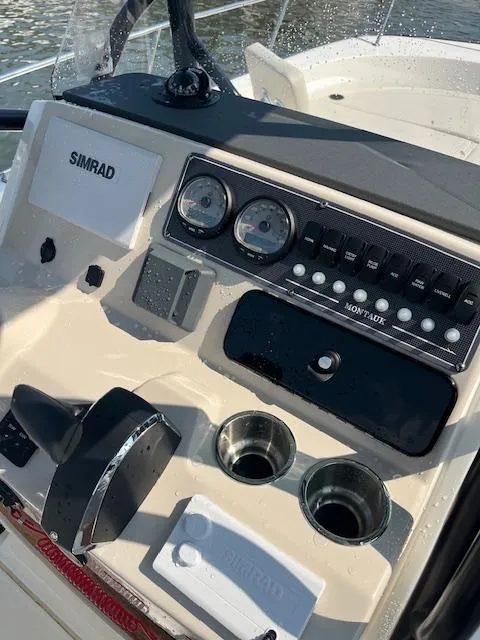 Slide: The Image of 2024 Boston Whaler 210 Montauk dashboard with Simrad electronics and control panel. - 8