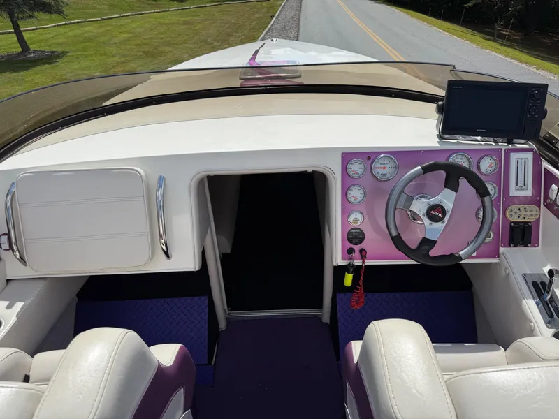 Slide: The Image of Interior of a 2006 Velocity VR1 boat with steering wheel and dashboard controls. - 11