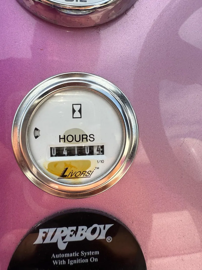 Slide: The Image of Hour meter reading 4104 on a 2006 Velocity VR1, pink background. - 13