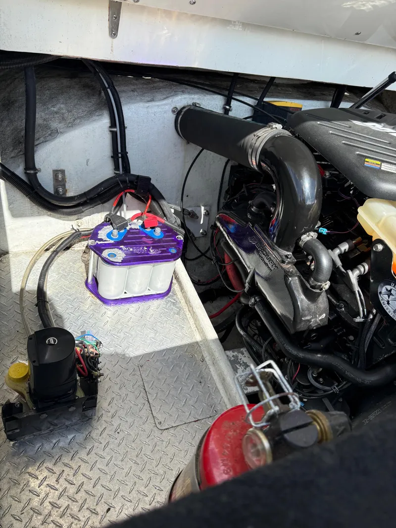 Slide: The Image of Engine compartment of a 2006 Velocity VR1 boat, featuring battery and mechanical components. - 16