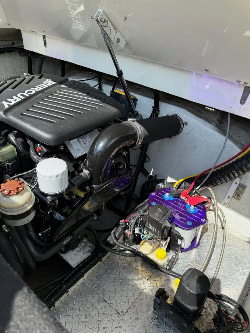 Slide: The Image of Engine compartment of a 2006 Velocity VR1 boat, featuring a Mercury engine and battery setup. - 17