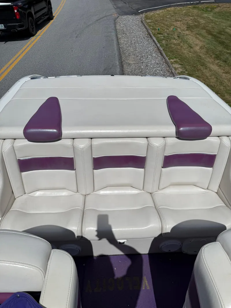 Slide: The Image of Rear view of a 2006 Velocity VR1 boat with white and purple seating. - 18