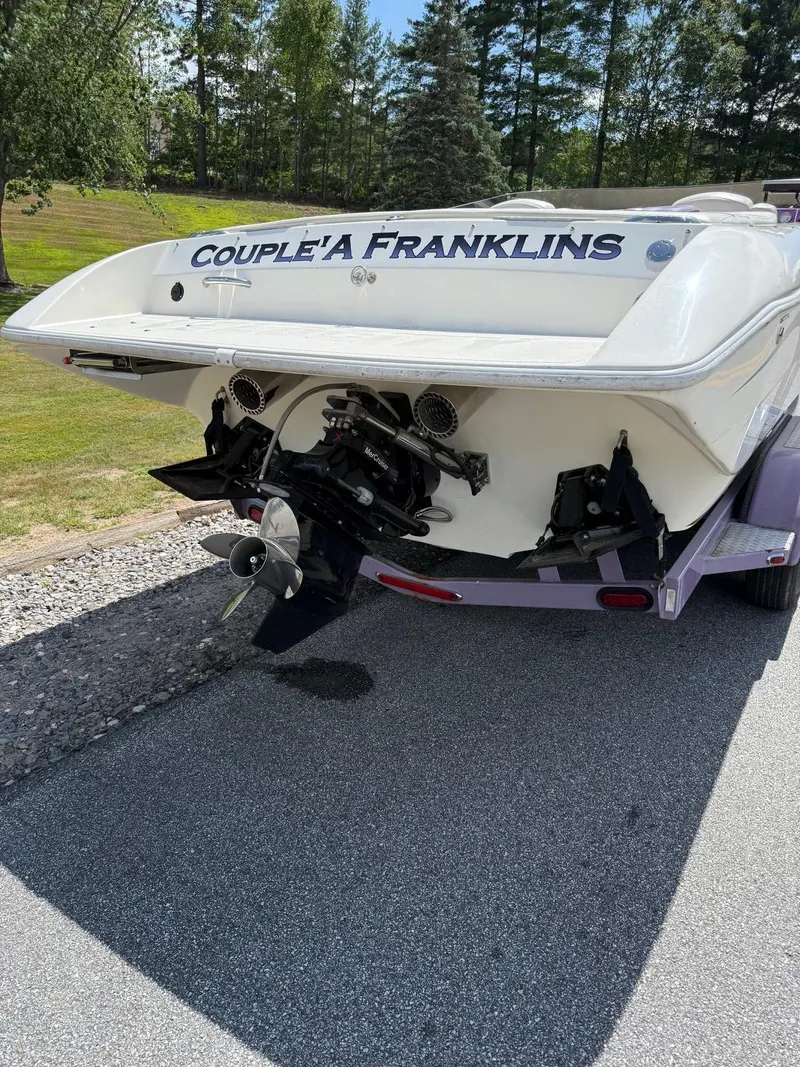 Slide: The Image of 2006 Velocity VR1 boat on trailer, rear view with "Couple'a Franklins" text. - 4
