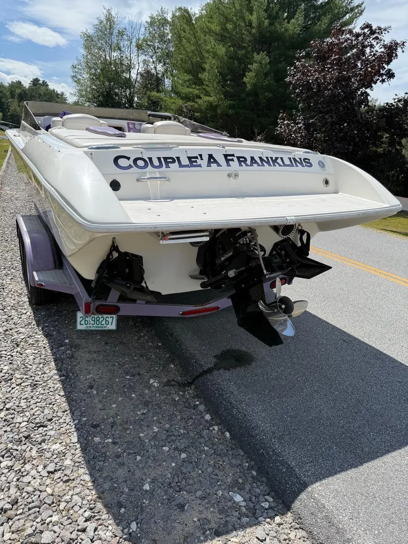 Slide: The Image of 2006 Velocity VR1 boat on trailer, named "Couple'a Franklins," parked roadside. - 5