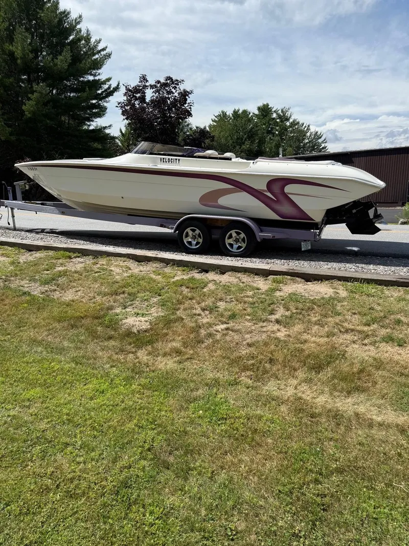 Slide: The Image of 2006 Velocity VR1 speedboat on trailer, parked outdoors on a sunny day. - 6