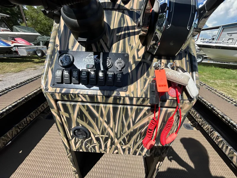 Slide: The Image of Control panel of a 2023 Prodigy 2070 boat with camouflage design and key accessories. - 10