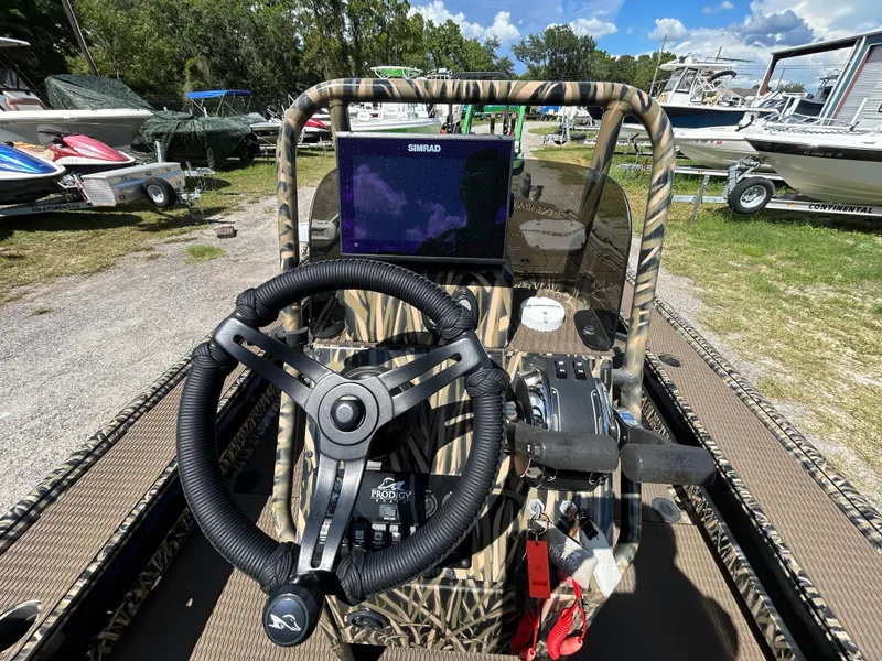 Slide: The Image of Boat dashboard with steering wheel and navigation screen, Prodigy 2070, 2023 model. - 11