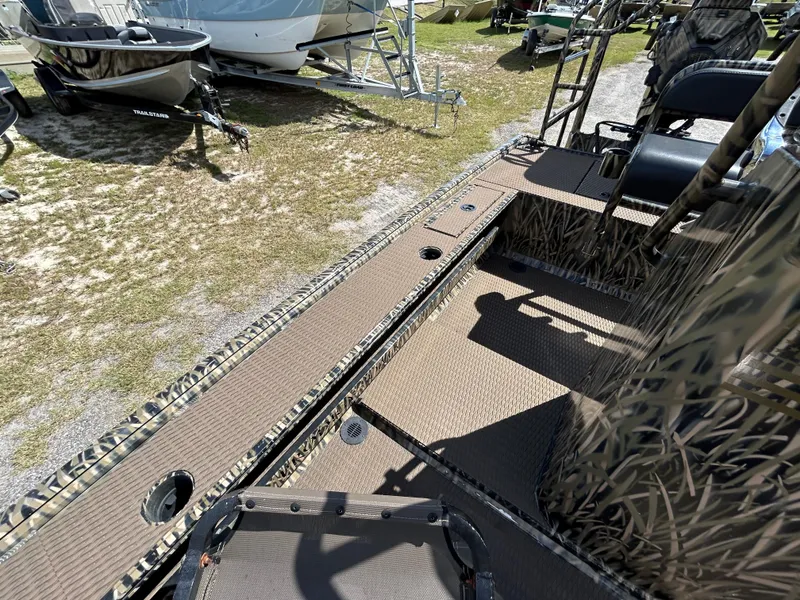 Slide: The Image of Camouflage-patterned Prodigy 2070 boat interior, 2023 model, with seating and storage compartments. - 14