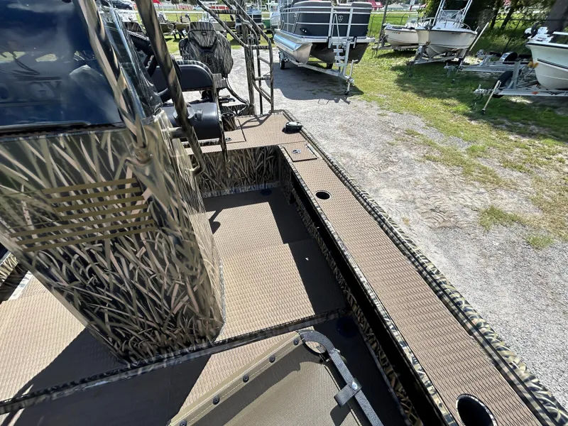 Slide: The Image of Camouflage-patterned Prodigy 2070 boat interior, 2023 model, with seating and storage compartments. - 15