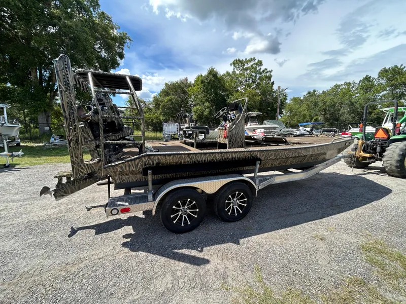 Slide: The Image of 2023 Prodigy 2070 boat on trailer, parked outdoors under a partly cloudy sky. - 4