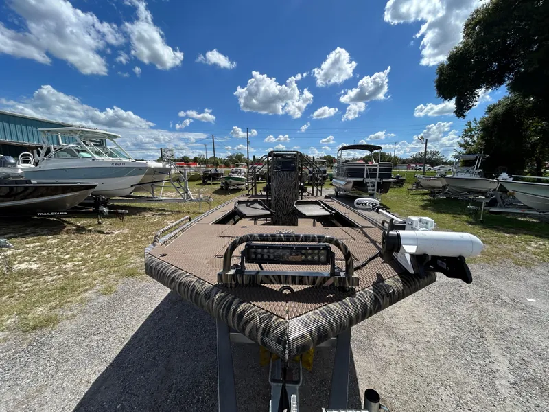 Slide: The Image of Prodigy 2070 boat, 2023 model, displayed outdoors under a bright blue sky. - 6