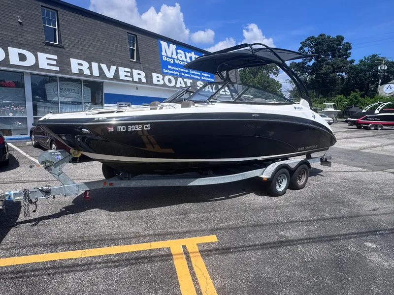 Slide: The Image of 2016 Yamaha 242 Limited S E-Series boat on trailer at dealership. - 1