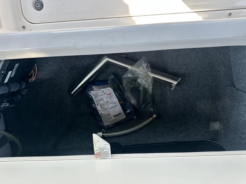 Slide: The Image of Storage compartment of a 2016 Yamaha Boats 242 Limited S E-Series with accessories and parts. - 19