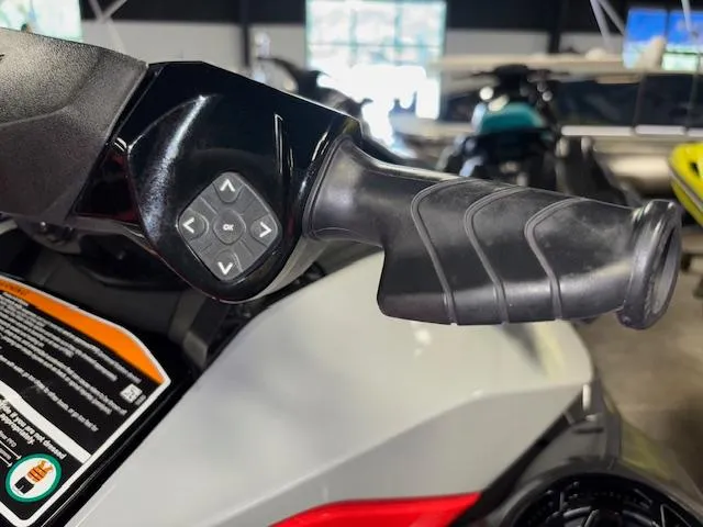 Slide: The Image of 2023 Sea-Doo GTI SE handlebar with control buttons in a showroom setting. - 10
