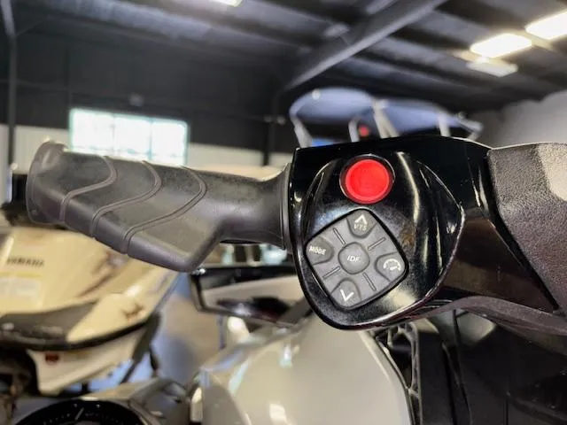 Slide: The Image of Close-up of 2023 Sea-Doo GTI SE handlebar controls in a showroom. - 11