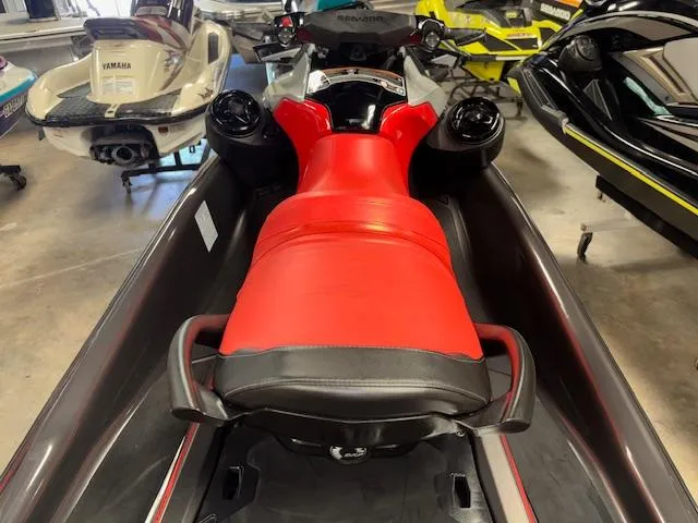 Slide: The Image of 2023 Sea-Doo GTI SE with red seat, displayed in a showroom. - 8