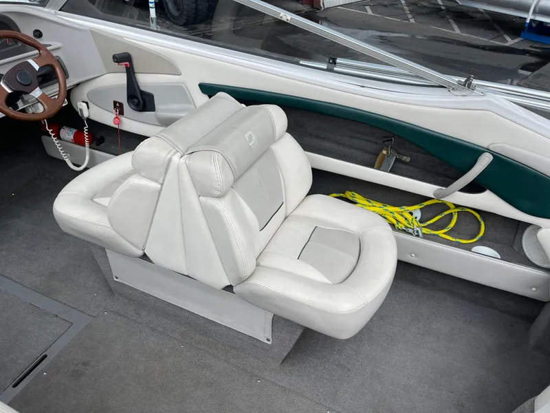 Slide: The Image of Interior of a 1995 Four Winns 240 Horizon boat with white seating and steering wheel. - 11