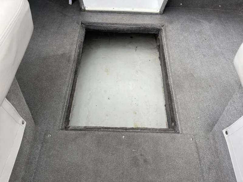 Slide: The Image of Interior view of a 1995 Four Winns 240 Horizon boat with open storage compartment. - 17