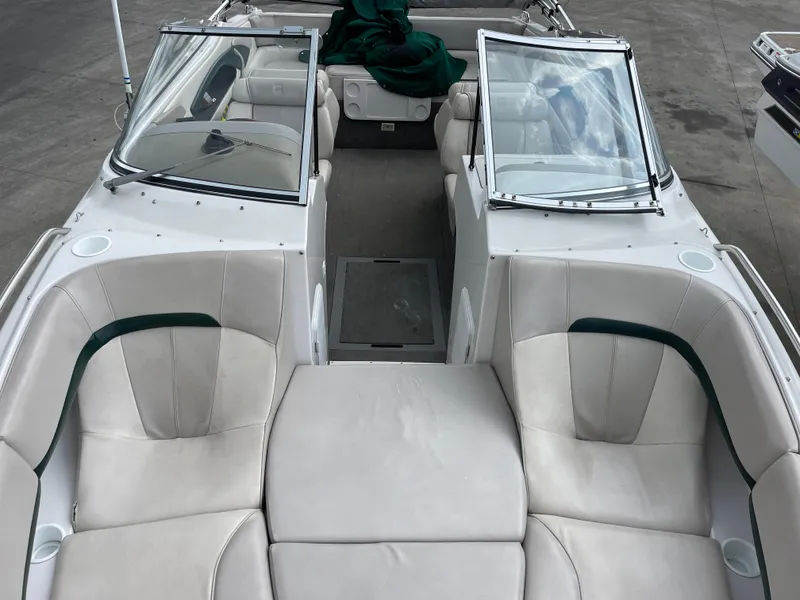 Slide: The Image of 1995 Four Winns 240 Horizon boat interior with white seating and windshield. - 20