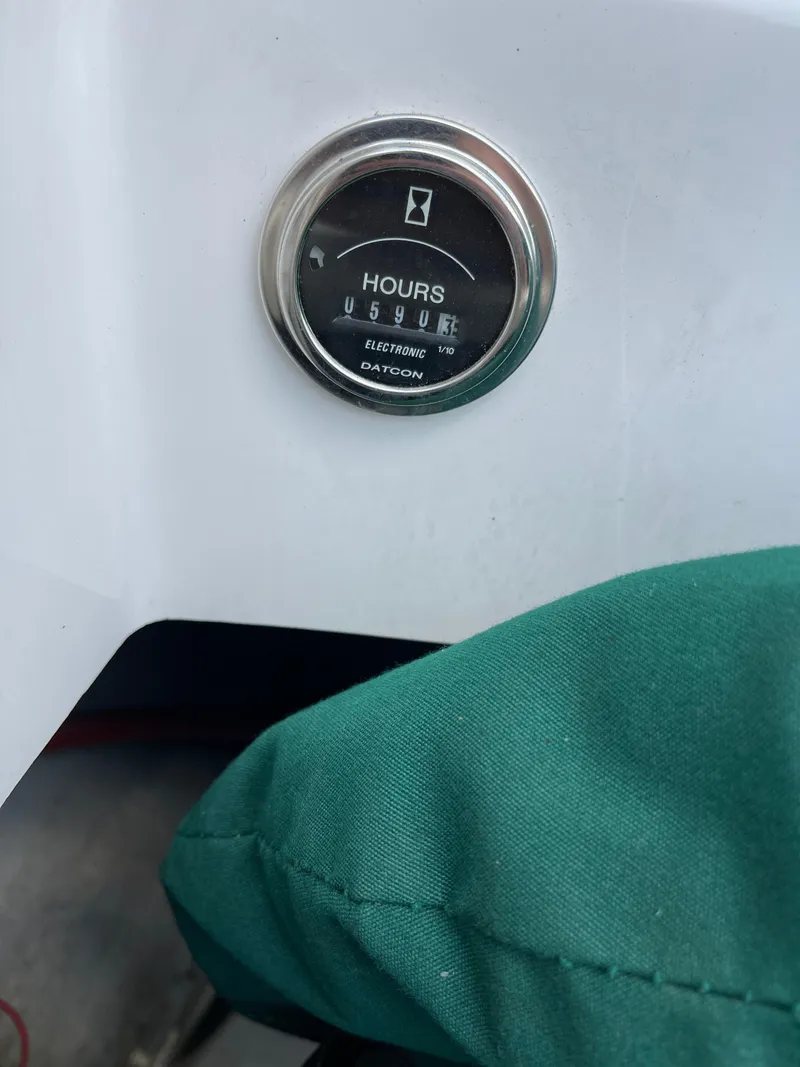 Slide: The Image of Hour meter on 1995 Four Winns 240 Horizon boat dashboard, showing 590.5 hours. - 22