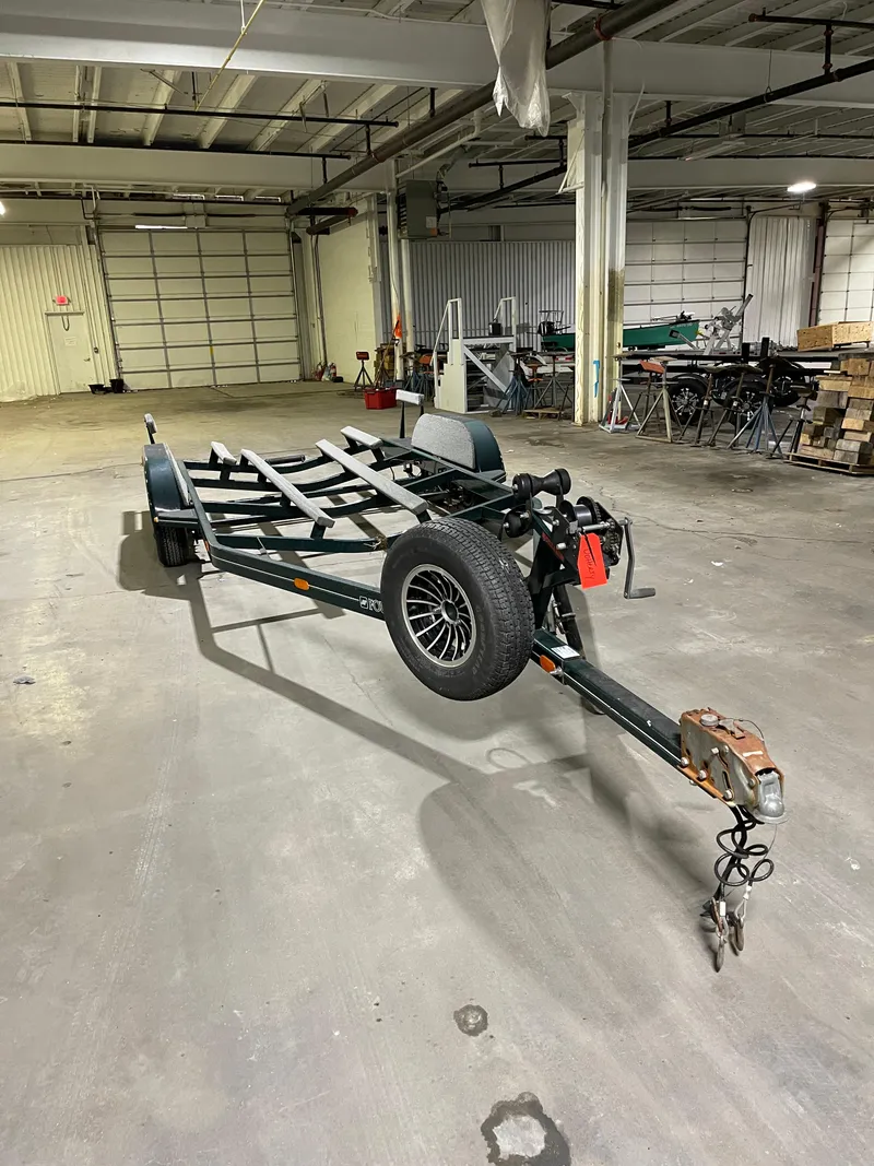 Slide: The Image of Boat trailer for 1995 Four Winns 240 Horizon in a spacious warehouse. - 23