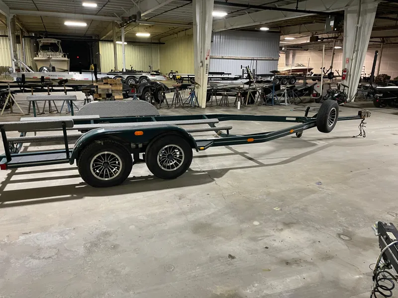 Slide: The Image of 1995 Four Winns 240 Horizon boat trailer in a spacious indoor storage facility. - 25