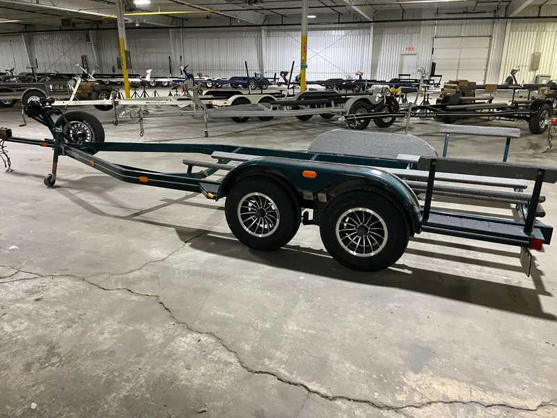 Slide: The Image of Boat trailer for 1995 Four Winns 240 Horizon in a warehouse setting. - 26