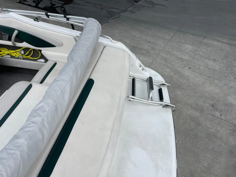 Slide: The Image of 1995 Four Winns 240 Horizon boat interior with seating and ladder. - 6