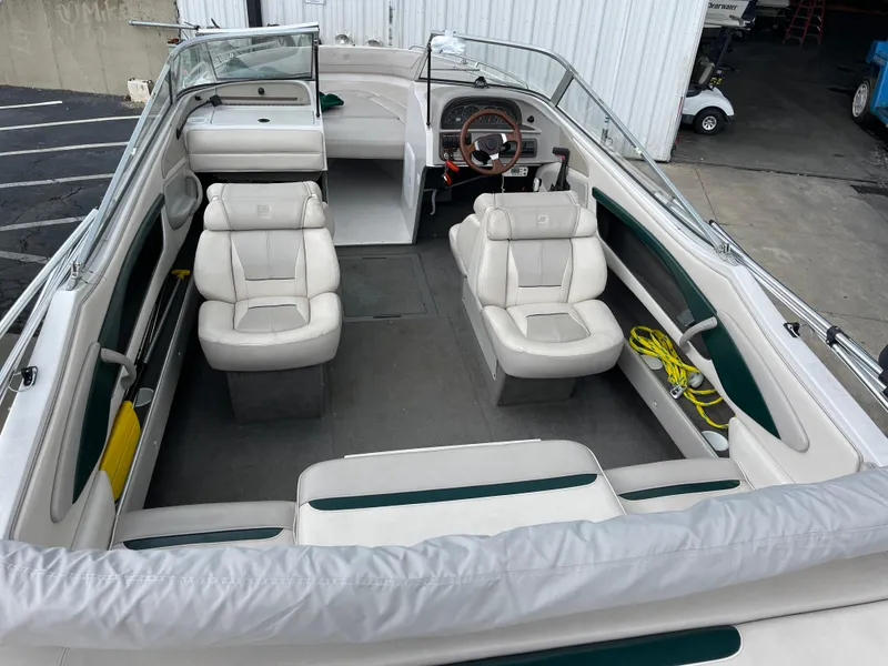 Slide: The Image of 1995 Four Winns 240 Horizon boat interior with white seating and steering wheel. - 7