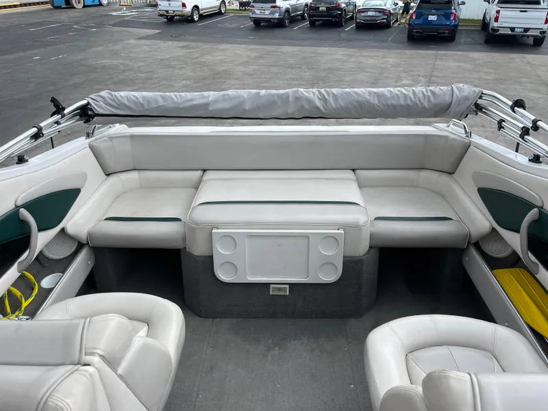 Slide: The Image of 1995 Four Winns 240 Horizon boat interior with white seating and cup holders. - 8