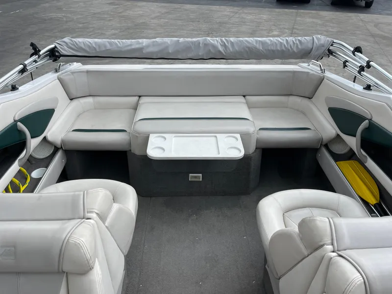 Slide: The Image of Interior of a 1995 Four Winns 240 Horizon boat with white seating and cup holders. - 9