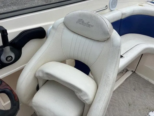 Slide: The Image of 2006 Rinker 232 Captiva Bowrider interior with white and blue seating. - 11