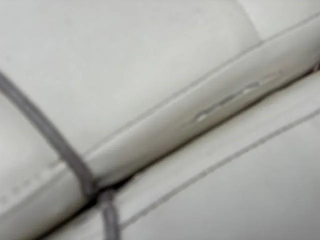 Slide: The Image of Close-up of 2006 Rinker 232 Captiva Bowrider's white leather seat stitching. - 12