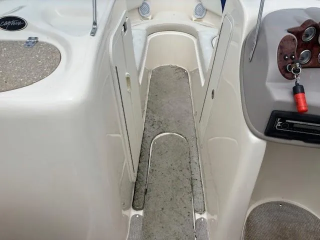 Slide: The Image of 2006 Rinker 232 Captiva Bowrider interior with dashboard and seating area. - 15